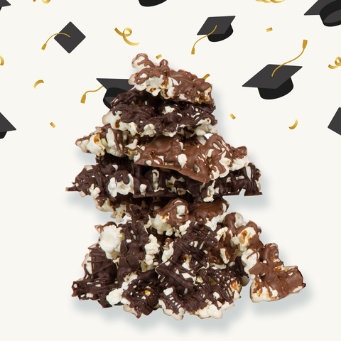 Graduation-themed chocolate-covered popcorn with festive confetti and cap decorations, perfect for celebrating academic milestones.