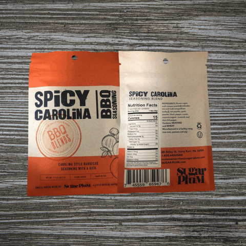 Spicy Carolina BBQ Seasoning packaging on a wooden table, showcasing nutritional information and branding by Sugar Plum.