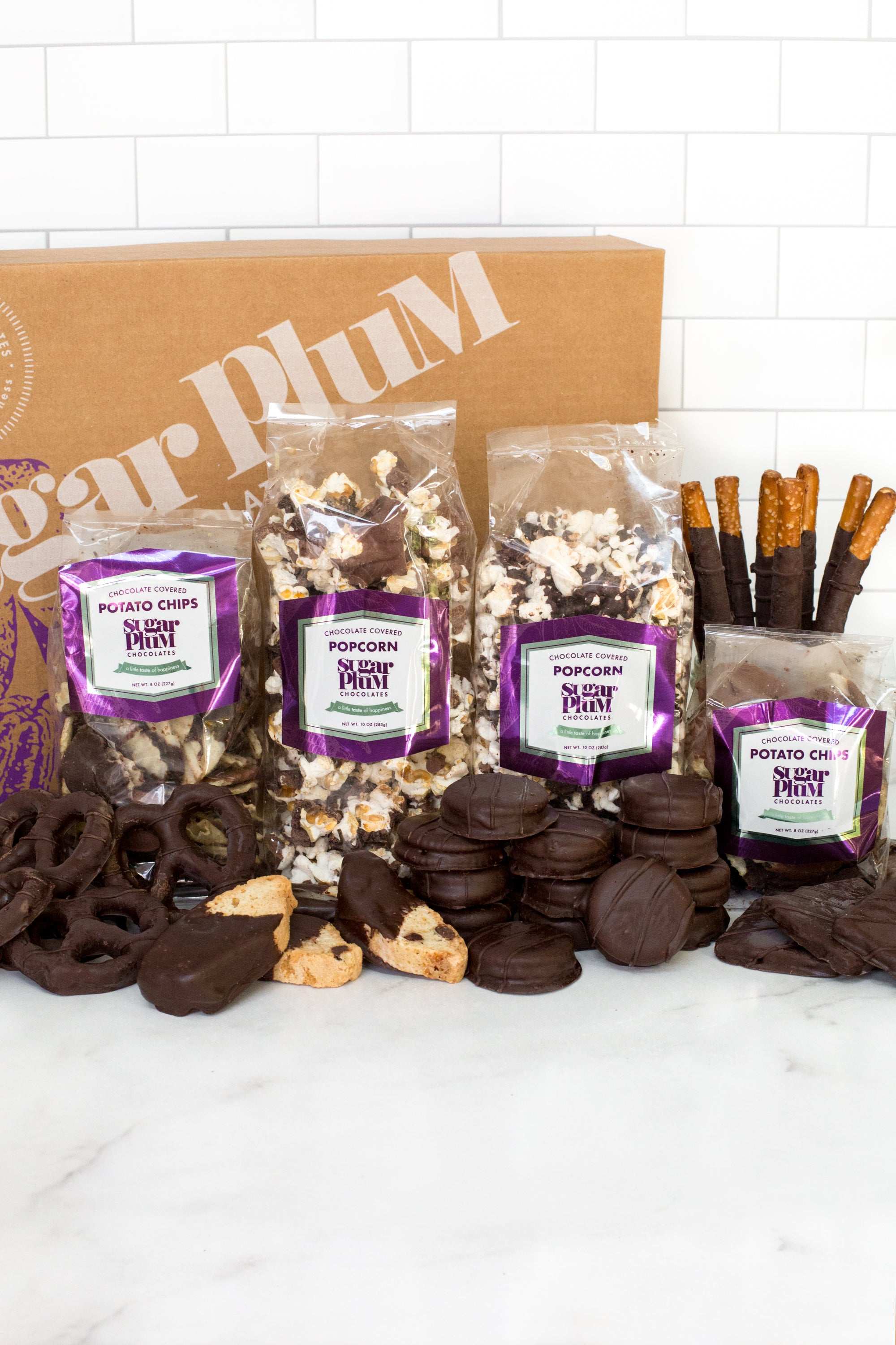 Double Decadence Dark Chocolate Gift Box with 42 gourmet snacks including popcorn, pretzels, and potato chips, perfect for gifting.