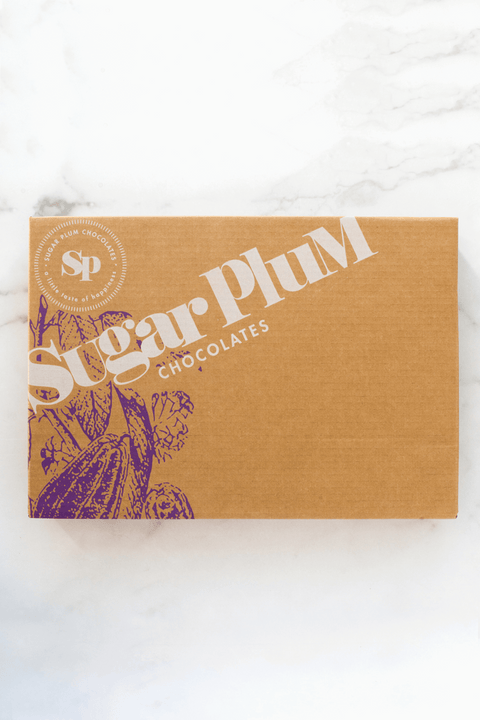 Sugar Plum Double Decadence Dark Chocolate Gift Box on marble background, perfect for special occasions and gifting.