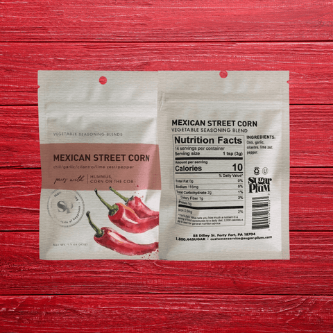 Mexican Street Corn Vegetable Seasoning 5-pack with chili, lime, garlic spice blend on red wood background.