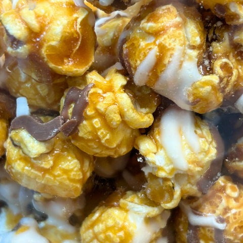 Closeup of Sugar Plum Caramel Corn with White and Milk Chocolate Drizzle 