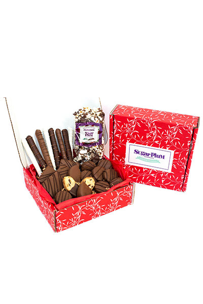 Chocolate Eruption Gourmet Chocolate Gift Box with 26 hand-dipped treats including cookies, popcorn, and pretzels in a red box.