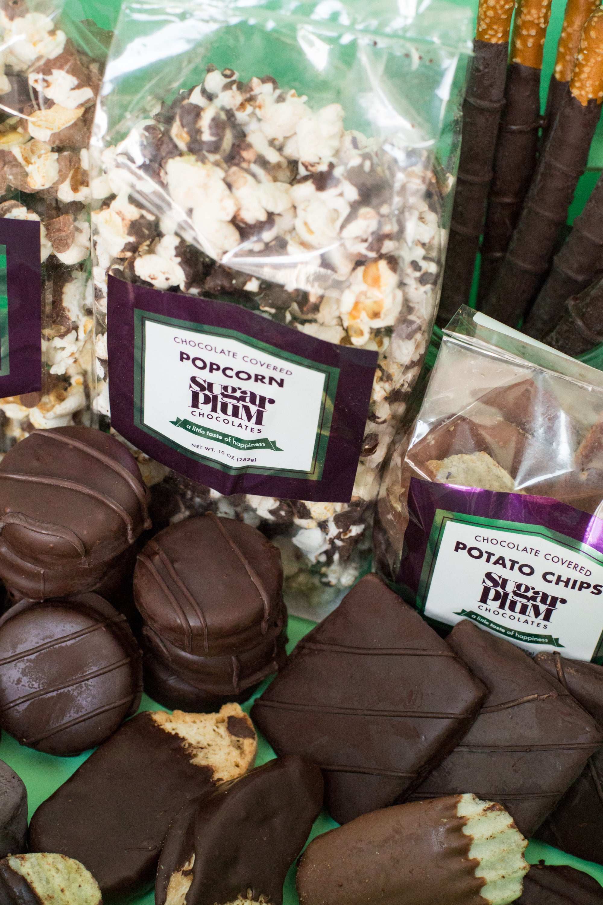 Gourmet dark chocolate gift box with popcorn and potato chips, offering a 42-piece assortment of handcrafted snacks for special occasions.