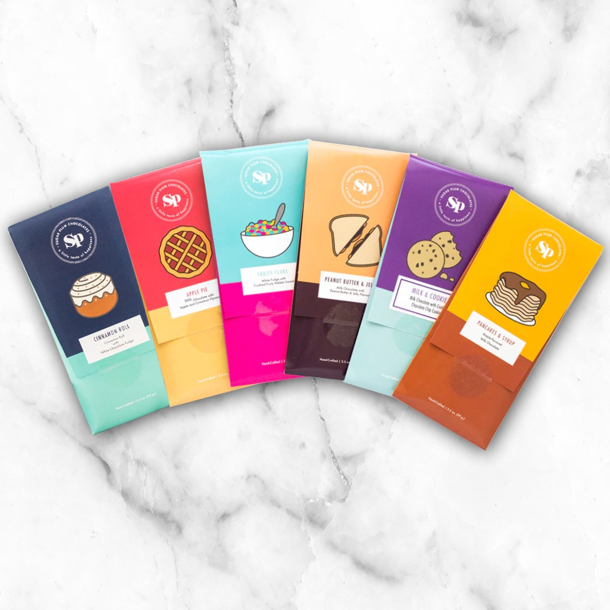 Nostalgic Chocolate Bars 6 Pack in childhood-inspired flavors, displayed on a marble surface.