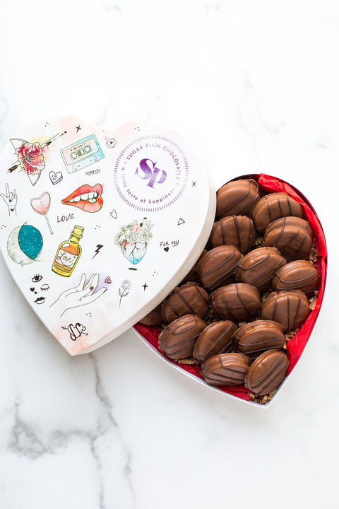 Milk Chocolate filled with Peanut Butter Cookies in a artistic heart-shaped box.