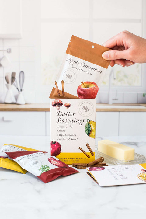 Butter seasonings spice pack in kitchen with Apple Cinnamon, Lemon Garlic, Umami Butter, and Sun-Dried Tomato flavors for cooking.
