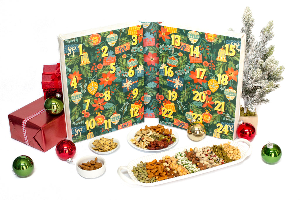 Advent calendar with Christmas-themed design, surrounded by festive decorations and snacks on a white background.