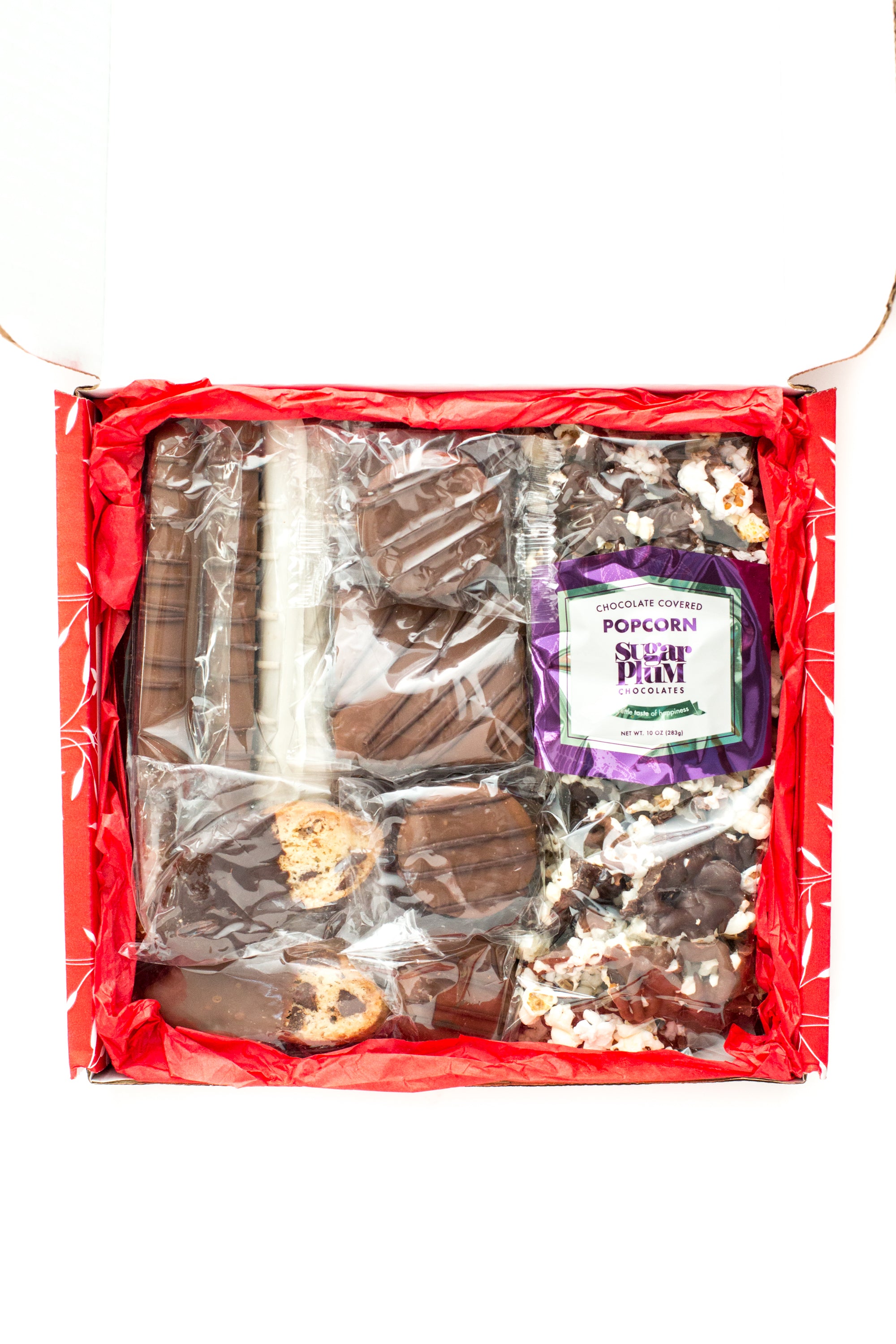Chocolate Eruption Gourmet Gift Box with 26 hand-dipped treats, featuring assorted chocolates, cookies, popcorn, and pretzels. Perfect gift.