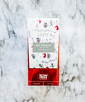 Peppermint Latte Chocolate Bar with festive packaging on marble background