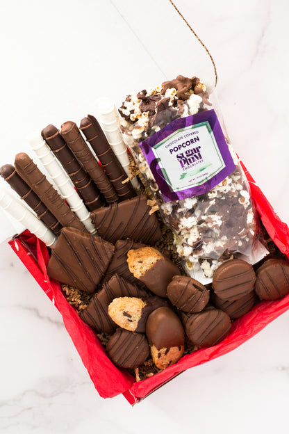 Chocolate Eruption Gourmet Gift Box with hand-dipped pretzels, cookies, and popcorn, ideal for gifting or sharing.
