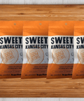 Sweet Kansas City BBQ Seasoning 5 Pack on wooden table, featuring handcrafted barbecue blend packaging.