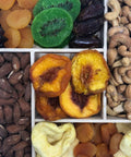 Gourmet dried fruit and nut tray with apricots, kiwis, cashews, and almonds on a wooden platter, perfect healthy snack gift.