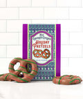 Holiday chocolate pretzels gift box with decorated treats, festive holiday packaging and snacks, perfect winter gift idea.