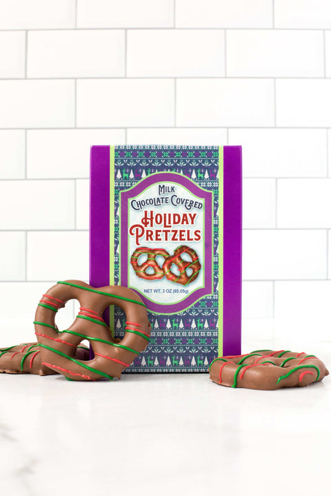 Holiday chocolate pretzels gift box with decorated treats, festive holiday packaging and snacks, perfect winter gift idea.