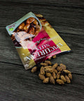 Epicurean Nuts Cherry Almonds spilled from 4 oz resealable bag, showcasing gourmet California almonds with natural cherry flavor.