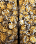 Gourmet caramel corn with white and milk chocolate drizzle in a gift box, handcrafted snack by Sugar Plum.