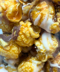 Closeup of Sugar Plum Caramel Corn with White and Milk Chocolate Drizzle 
