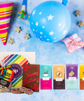 Deluxe Happy Birthday Gift Box with colorful gourmet snacks, including chocolate bars, gummies, and pretzels, perfect for celebrations.