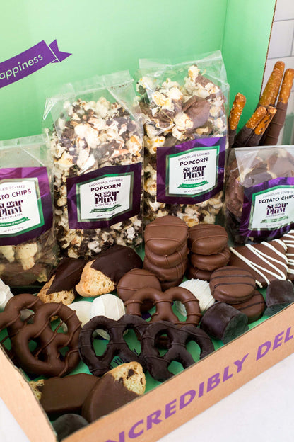 Gourmet chocolate assortment with pretzels, popcorn, and potato chips, hand-dipped in milk, dark, and white chocolates.