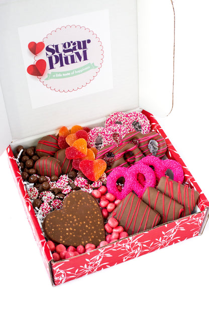 Happy Valentine's Day Box with chocolate treats, pretzels, cookies, and graham crackers, beautifully arranged for a perfect gift.