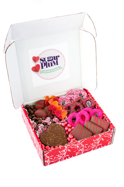 Valentine's Day Box with chocolate-covered pretzels, cookies, and graham crackers in a red decorative box.