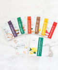 Veggie Lover's Cooking Spice Kit with six global spice packets and plant-based recipe book on a marble surface
