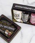 Beer & Bourbon Liquor Peanuts Tin with Jamaican Lager, Irish Stout, and Kentucky Bourbon flavors on marble background.