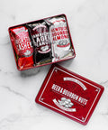 Beer & Bourbon Liquor Nuts Gift Tin with Irish Stout Cashews, Jamaican Lager Peanuts, Kentucky Bourbon Almonds on marble background.