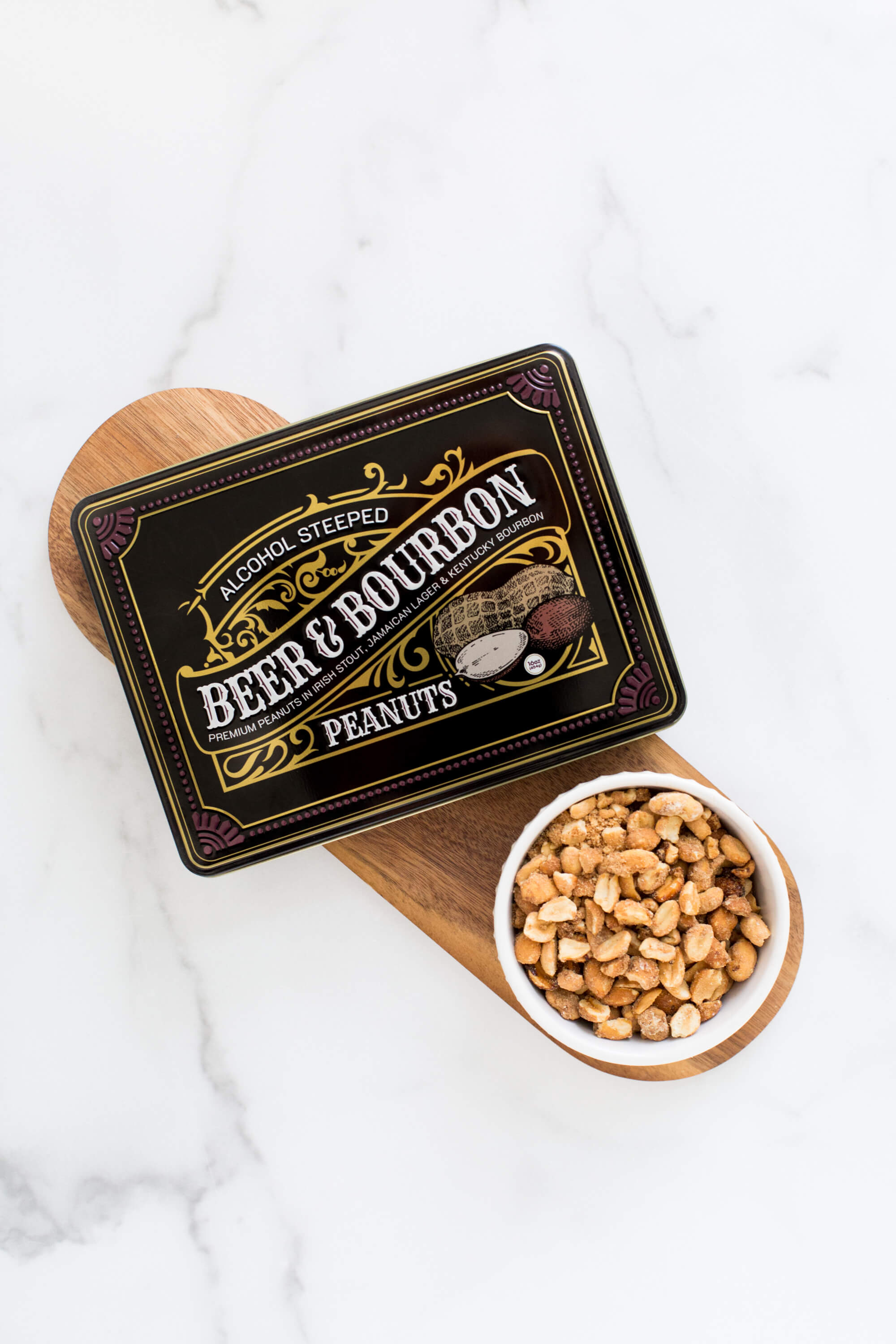 Gourmet Beer & Bourbon Liquor Peanuts Tin with roasted peanuts on wooden board.