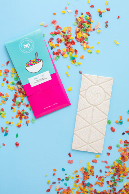 Nostalgic chocolate bar with colorful cereal-inspired packaging and toppings, handcrafted as part of Sugar Plum's unique candy collection.