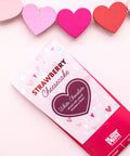 Strawberry Cheesecake White Chocolate Bar packaging with colorful heart decorations.