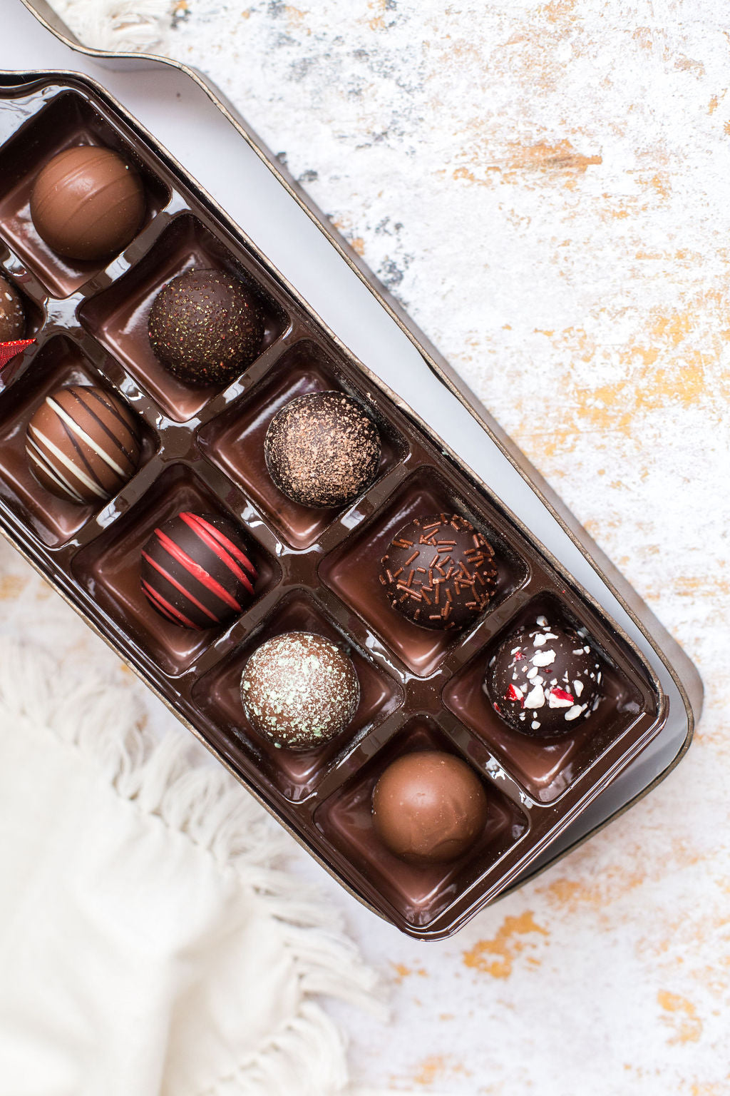 12-piece assortment of Sugar Plum’s incredible handcrafted chocolate truffles all beautifully laid out in a wine bottle-shaped box. 