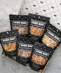 Manly Nut Box with six assorted bags of gourmet kettle-cooked nuts in a black and white gift box.