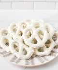 Plate of handcrafted white chocolate-covered pretzels from Pennsylvania, perfect for gifting or snacking.