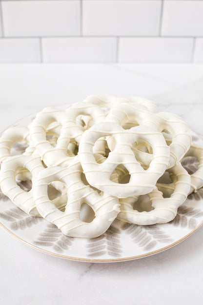 Plate of handcrafted white chocolate-covered pretzels from Pennsylvania, perfect for gifting or snacking.