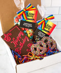 Box type packaging with the chromatic kettle corn, happy birthday chocolate ,pretzels and rainbow sour twist gummies. 