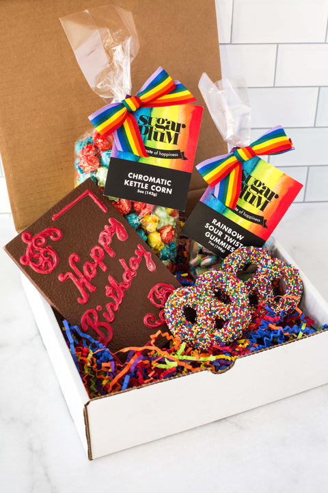 Box type packaging with the chromatic kettle corn, happy birthday chocolate ,pretzels and rainbow sour twist gummies. 