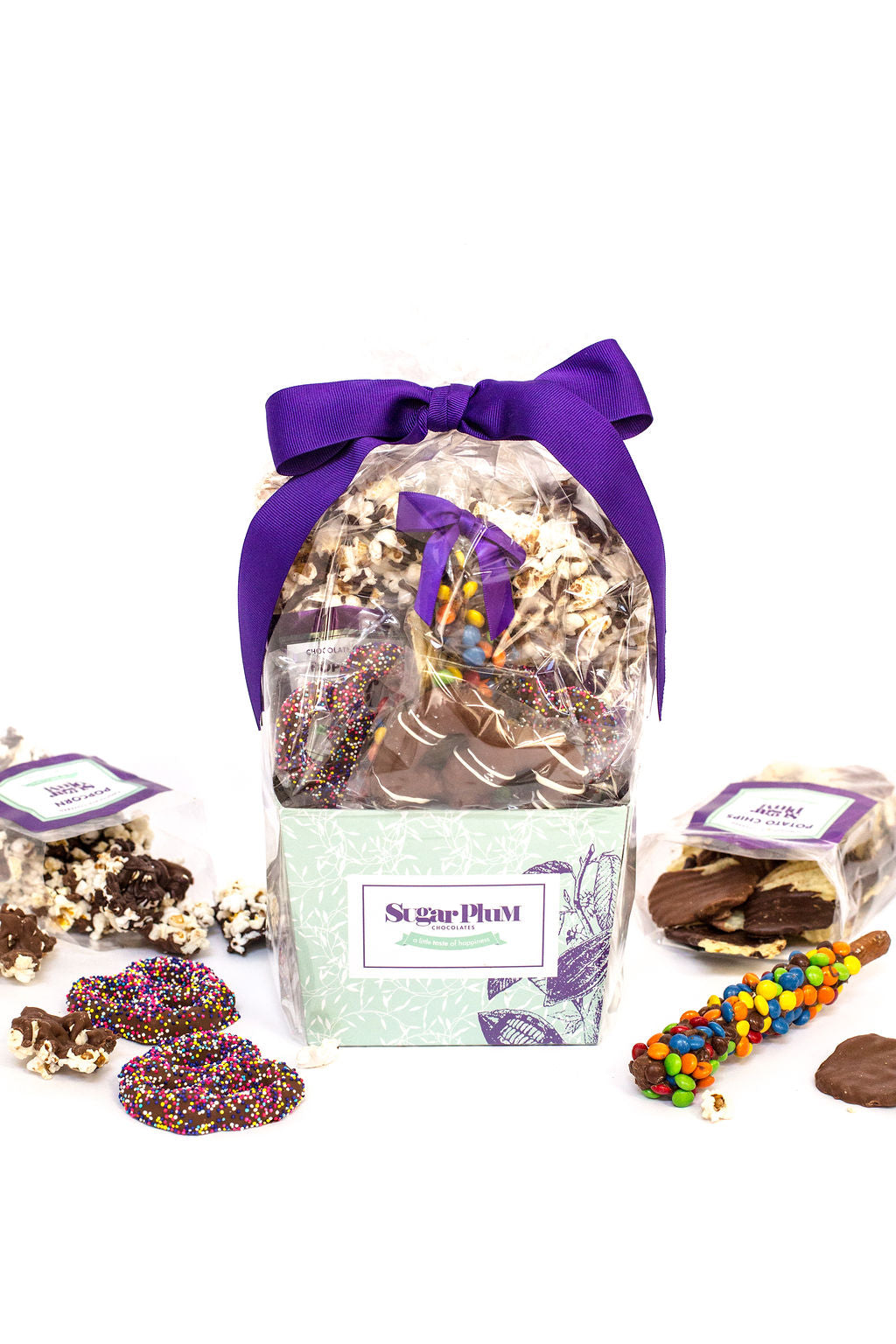 Gourmet chocolate gift basket with handcrafted treats by Sugar Plum, featuring chocolate-covered snacks, ideal for special occasions.