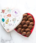 Milk Chocolate filled with Peanut Butter Cookies in a artistic heart-shaped box.