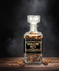 Signature Salted Cashew and Almonds in Glass Decanter with Smoke in Black Background