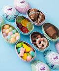 Sugar Plum Gourmet Easter Egg Hunt Sets includes complementary two-day shipping and features six unique decorative metal Easter eggs, including one egg filled with each of the following:  .85oz Mini Pretzels 1.6oz Pastel Mello Creme Candies 2oz Assorted Gummy Flowers 3oz Pastel Egg Jelly Beans 2 - Milk Chocolate-Covered Sandwich Cookies 1 - Milk Chocolate-Covered Marshmallow