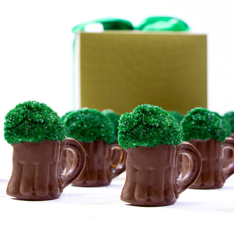 Milk chocolate beer mug assortment with green sprinkles, perfect for St. Patrick's Day celebration, boxed with festive ribbon.