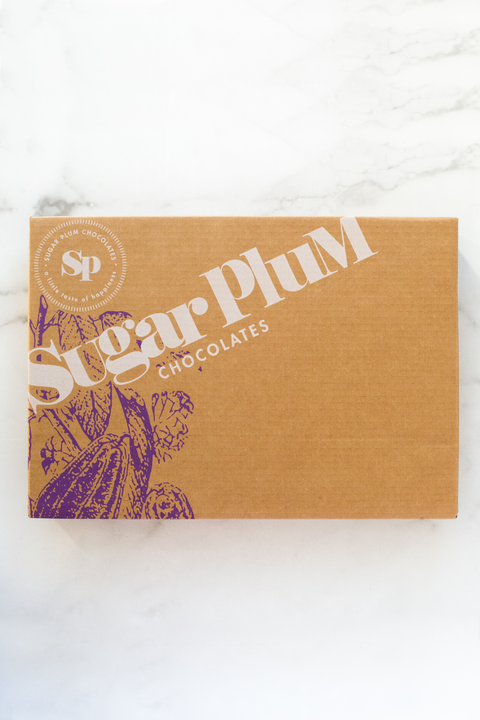 The picture shows a neat brown box packaging of sugar plum chocolates brand.