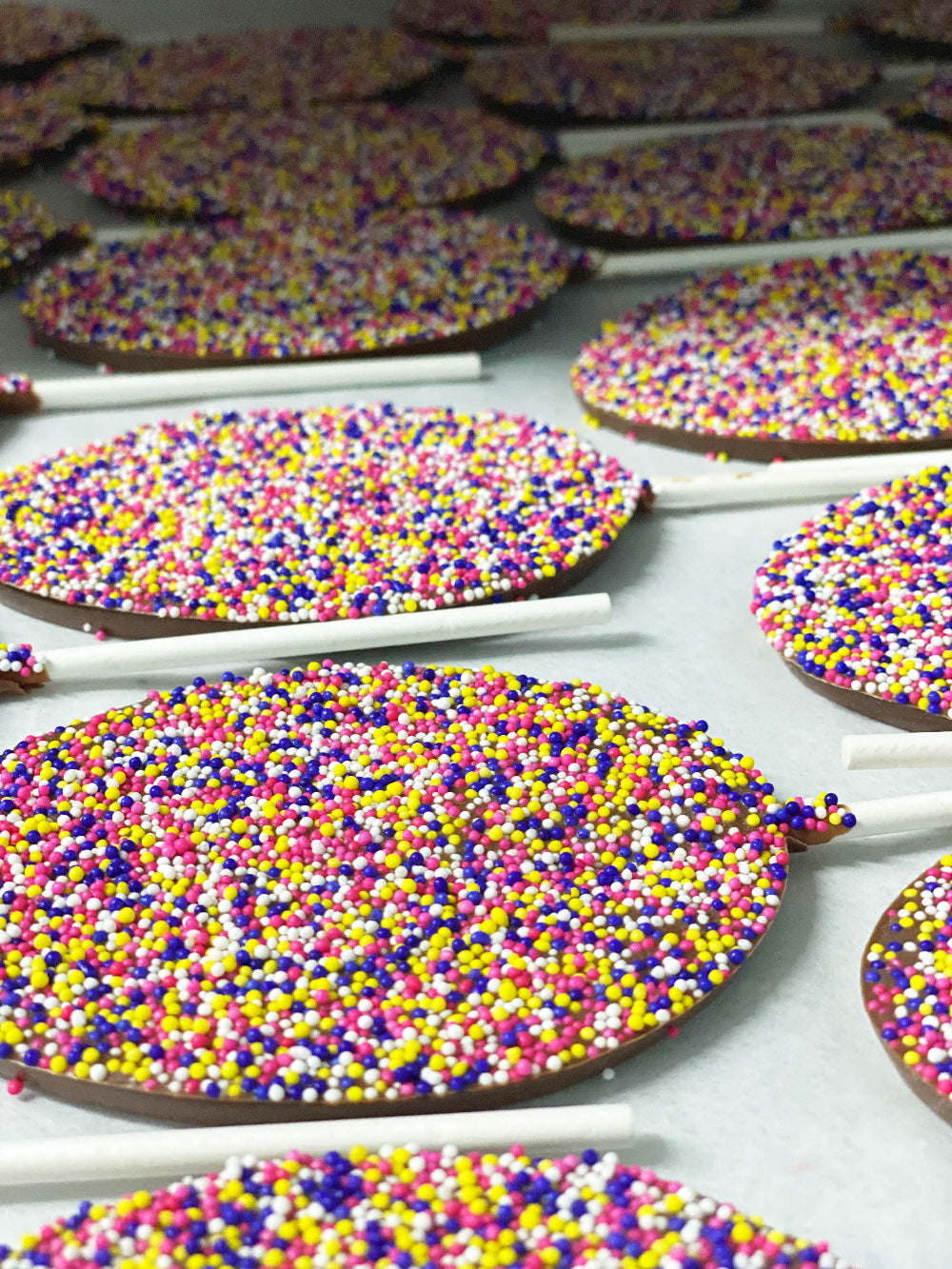 Easter Egg Nonpareil Lollipops with colorful sprinkles, perfect for festive Easter baskets, set of six chocolate treats.